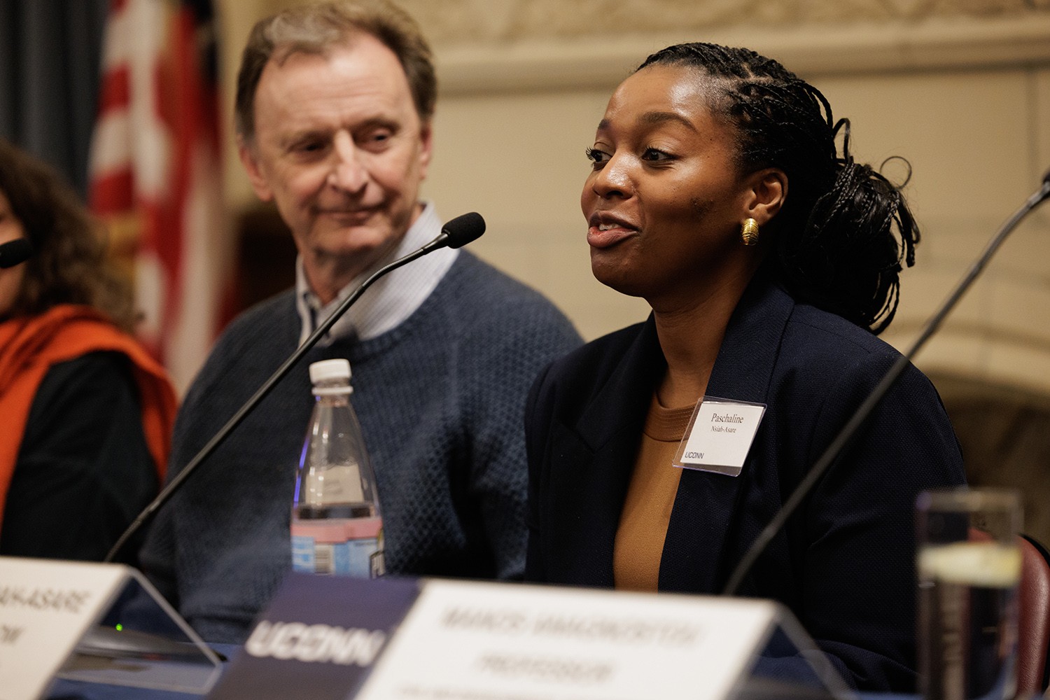 Paschaline Nsiah-Asare sits at a table during a panel discussion.