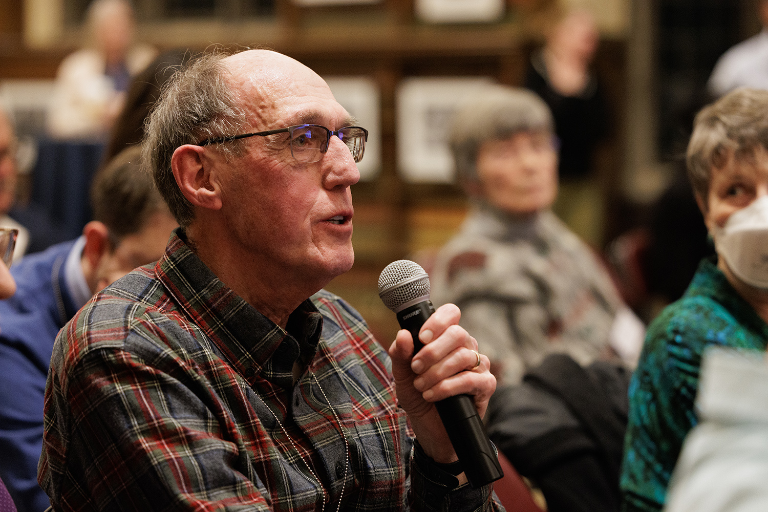 Charlie Whynacht holding a microphone.