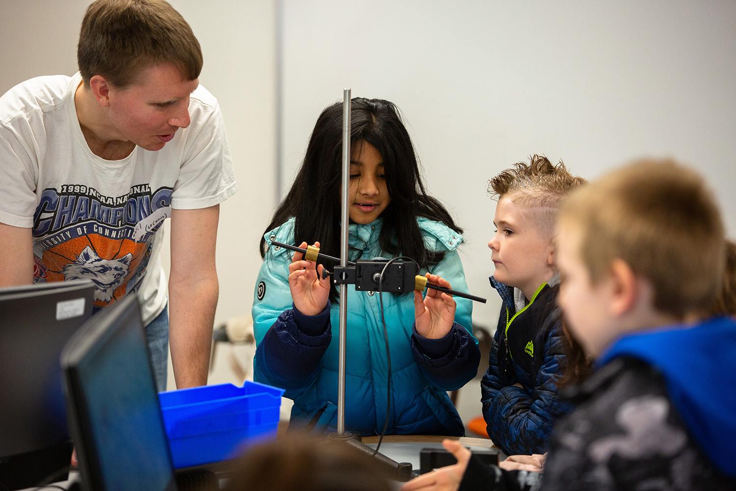 Will Wortley explains a physics activity to young students.