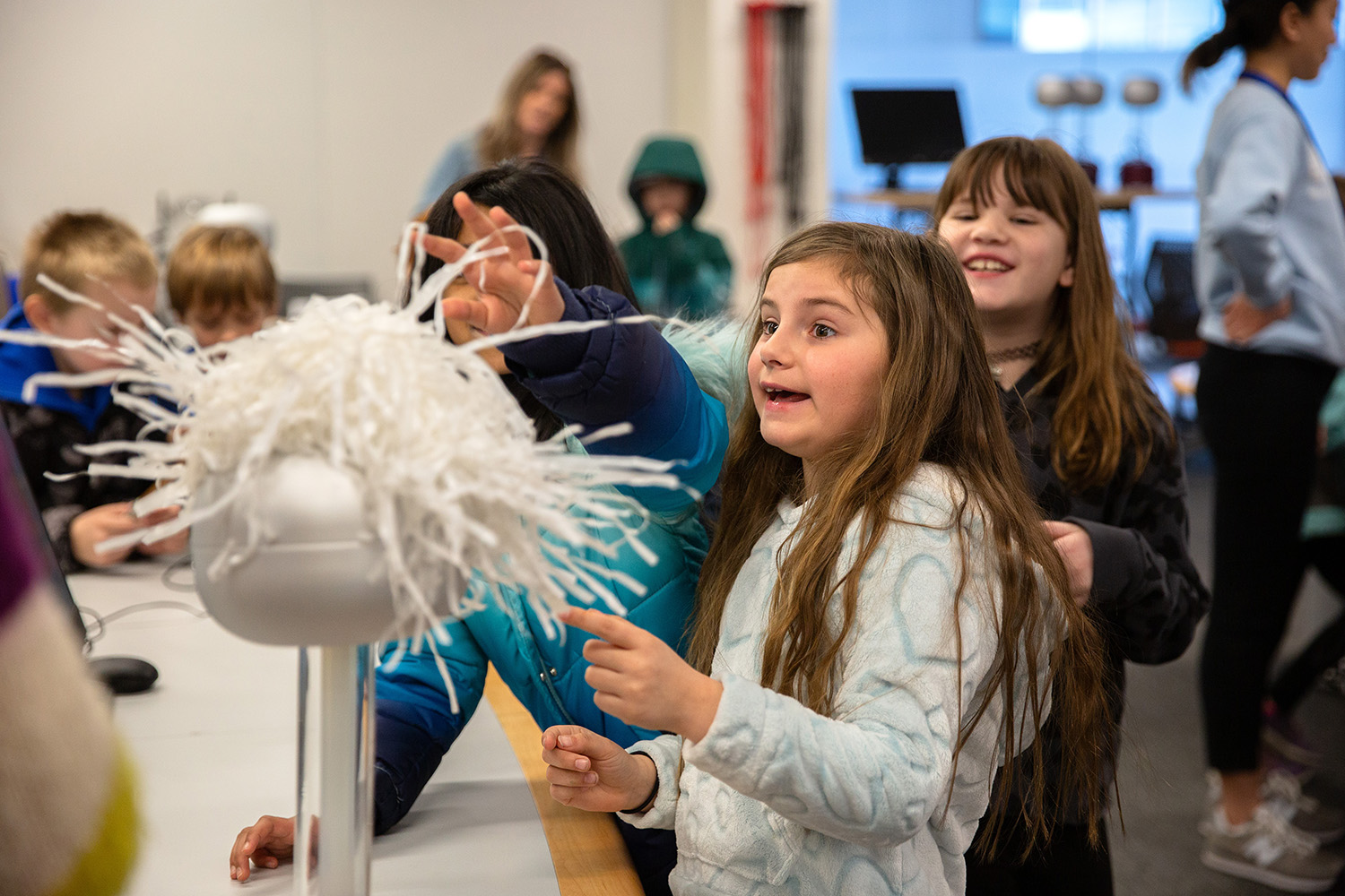 A student performs a physics activity during a trip to UConn's main campus in Storrs.