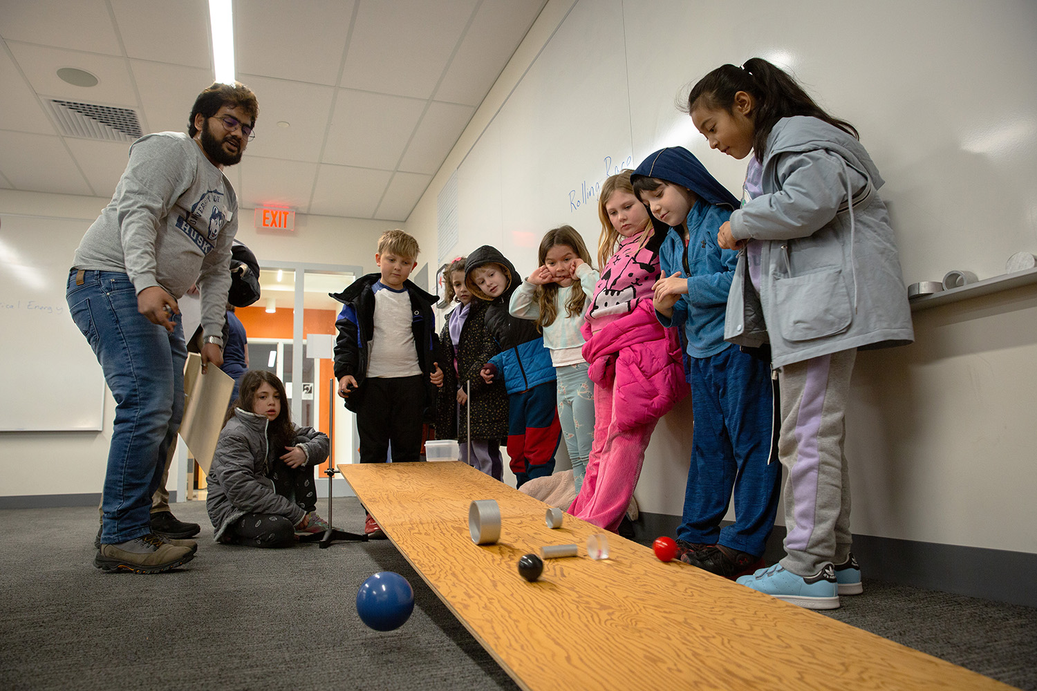 Sunil Andrew Anthony Belavendiran Stephen explains a physics activity to young students.