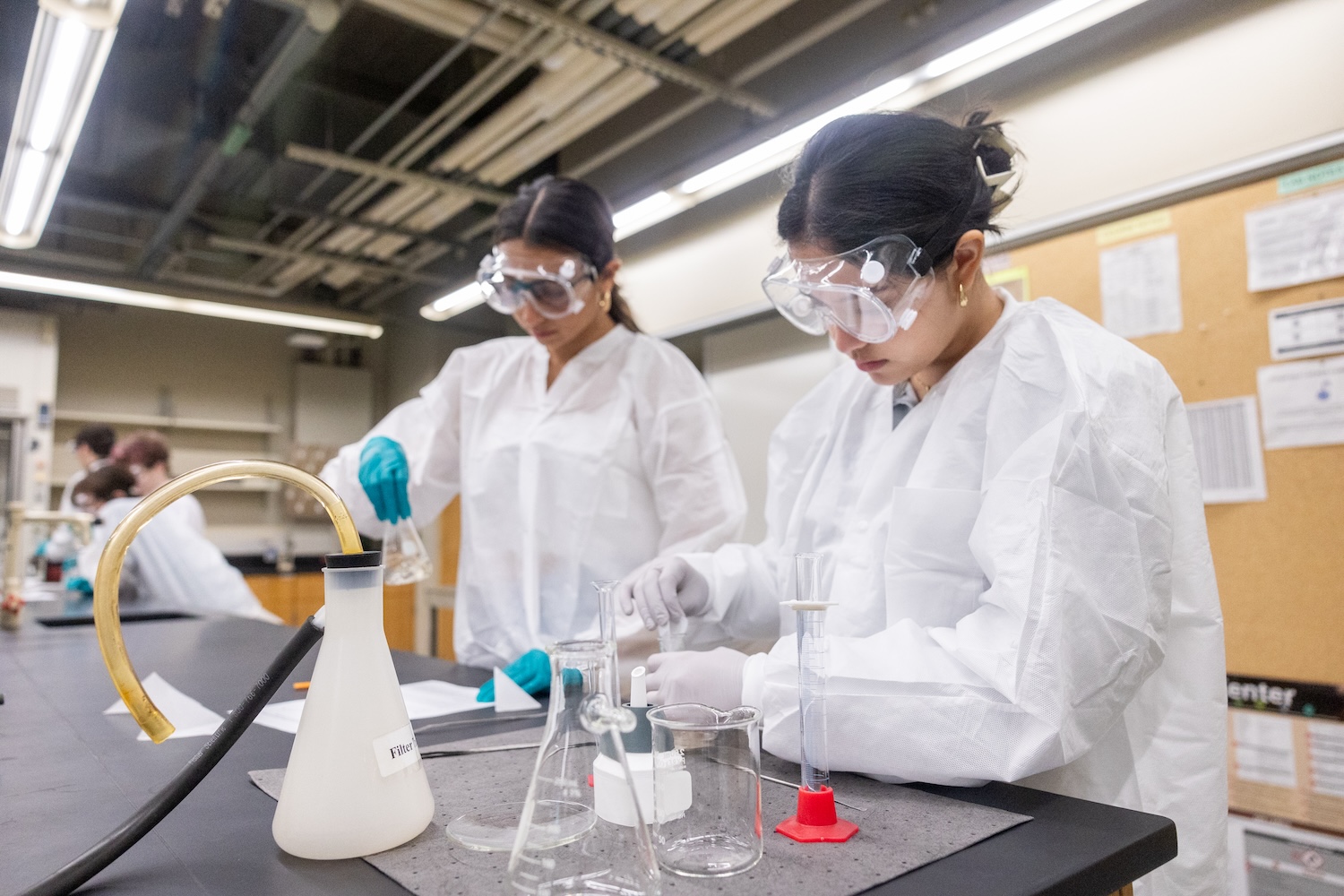 Two students performing an experiment in a lab. 