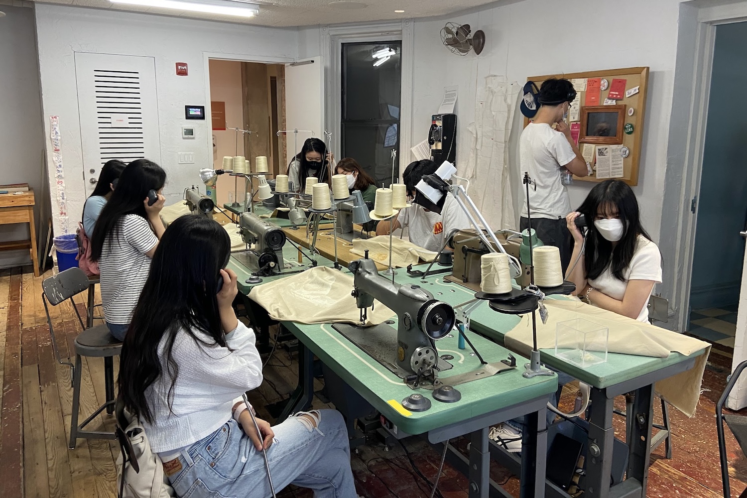 Students engaging with a garment shop exhibit at the Tenement Museum in Manhattan.