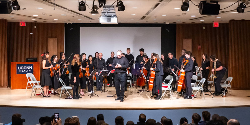 orchestra standing on stage