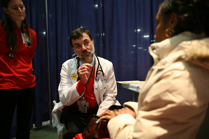 Dr. Bruce Gould talks to a patient during a free Care Clinic in Hartford. (Michael Fiedler for UConn Health Center)