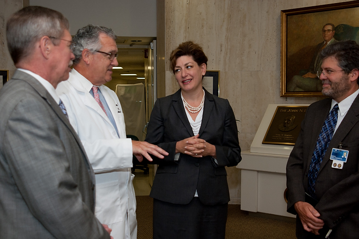 UConn President Susan Herbst talks with (left to right) Drs. Mike Summerer, Stephen Lahey, and Denis Lafreniere before a meeting with Health Center employees. (Tina Encarnacion/UConn Health Center Photo)