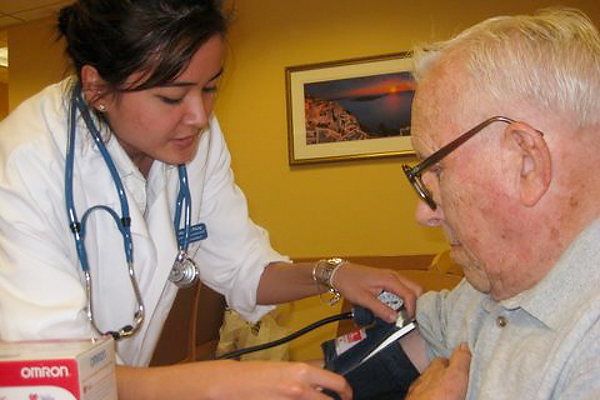 As part of National Primary Care Week, Michelle Pheng, at the time a second-year pharmacy student, sees a patient at the South End Senior Wellness Center in Hartford. (Connie Cantor/UConn Health Center Photo)