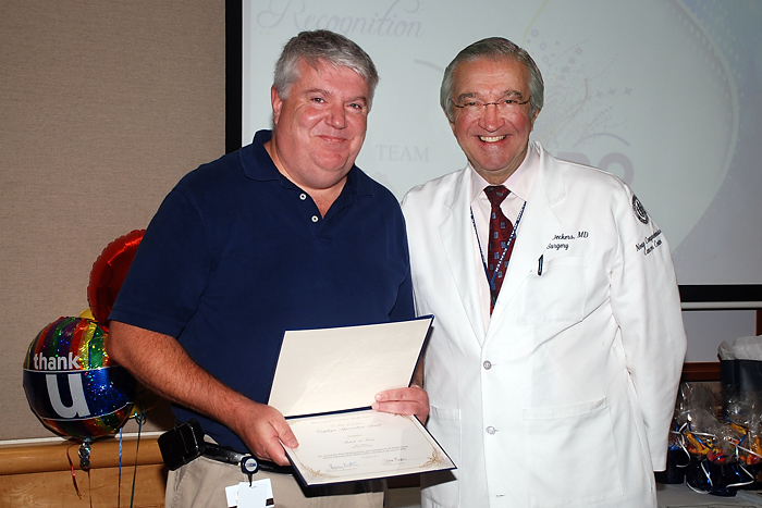 Dr. Peter Deckers (left) presents Robert Norris with the Dr. Peter J. Deckers Employee Appreciation Award on November 8, 2011. (Janine Gelineau/UConn Health Center Photo)