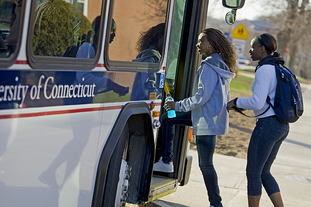 Students board a UConn bus.