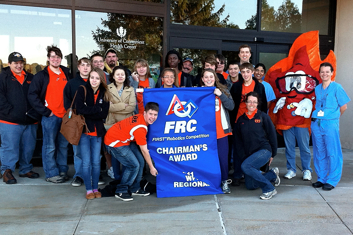 A robotics team made of high school students from Meriden and Wallingford during a recent visit to the Health Center. Dr. Christina Stevensen (left) and Dr. Angela Kueck are standing next to "Fuego" - the team's mascot.