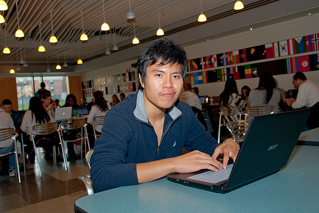 Pei-Kang Wu works on his laptop in the School of Business Cafe on Nov. 30, 2011. (Ariel Dowski/UConn Photo)