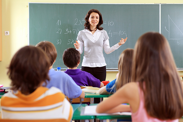 Teacher and students in a school classroom.