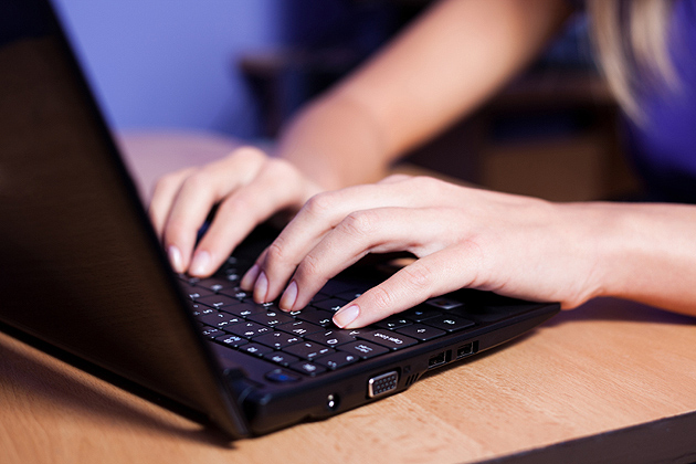 Person typing on a laptop.