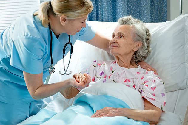 Nurse attending to an elderly person.