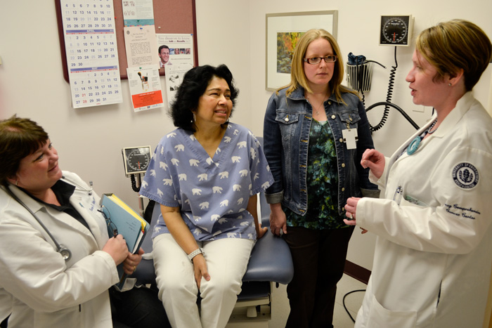 Nurse practitioner Karen Metersky, patient Zana Khan, and patient navigator Pam Nixon listen to clinical research assistant Melissa Parente. Parente, Metersky and Nixon organized the gynecologic cancer support group that holds its first meeting April 26. (Chris Defrancesco/UConn Health Center Photo)