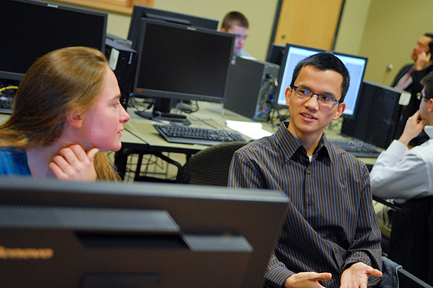 Brittany DePoy '13 (ENG), left, and Nhat-Tan Duong '13 (ENG) intern for Cigna in the computer lab in room 360 of the ITE Building on April 11, 2012. (Ariel Dowski/UConn Photo)