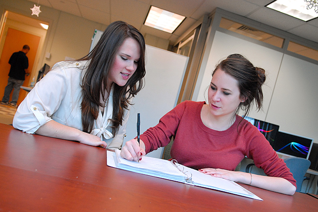 Kayla Everson '12, left, tutors Sarah Adams '12 in the Academic Achievement Center on Dec. 14, 2011. (Ariel Dowski/UConn Photo)