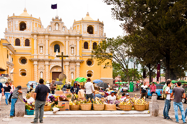 Antigua, Guatemala - April 17, 2011: Locals and visitors alike shop in the Semana Santa market in front of La Merced Cathedral.