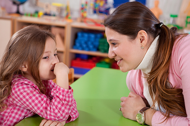 Teacher talking with little girl.