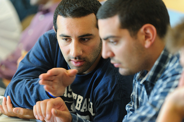 Adam Boyajian '12 (BUS), left, fine tunes his pitch with his partners during a meeting of the iQ inQbator program at the Student Union on June 13, 2012. (Peter Morenus/UConn Photo)