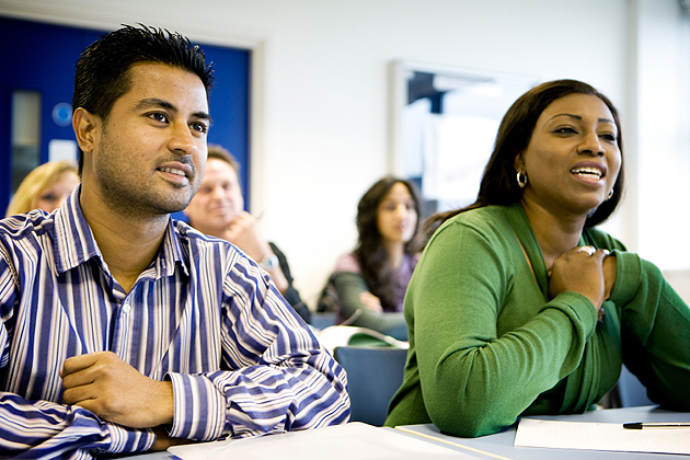 A pair of mature students engaging themselves in their lesson.