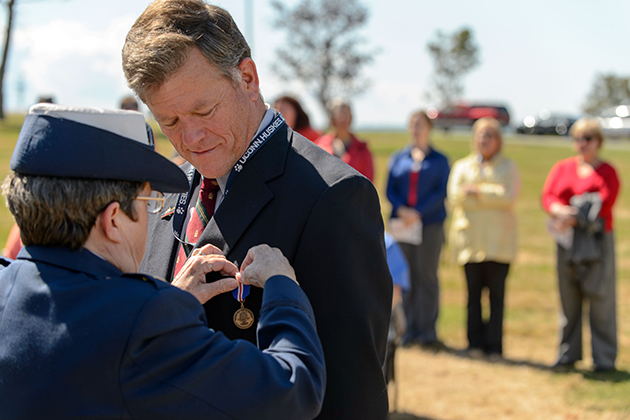 Linda S. Swartz, left, commissioner, Connecticut Department of Veteransâ Affairs awards a Connecticut veterans wartime service medal to Joseph Brubaker, an adjunct faculty member in political science during a ceremony held at the Avery Point campus on Sept. 24, 2012. (Peter Morenus/UConn Photo)