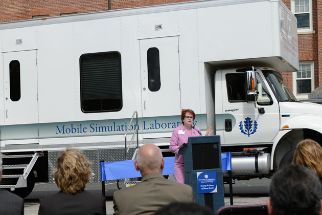 Regina Cusson, interim dean of nursing speaks at a ceremony to dedicate the Partnerships to Advance Nursing Practice's Mobile Simulation Laboratory outside Storrs Hall on Sept. 10, 2012. (Peter Morenus/UConn Photo)