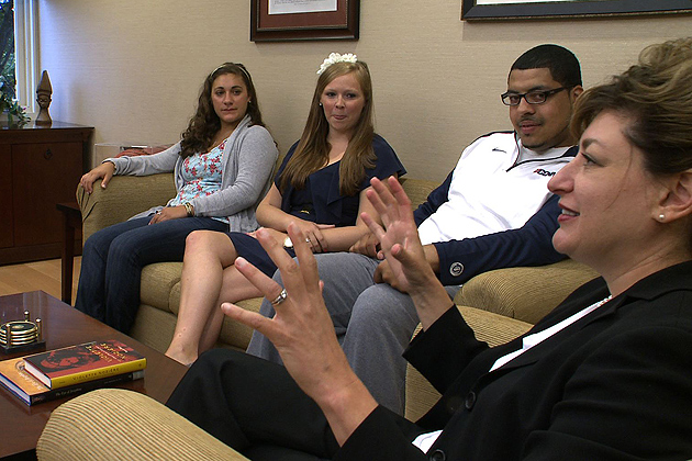 President Susan Herbst -speaking with students at her office.