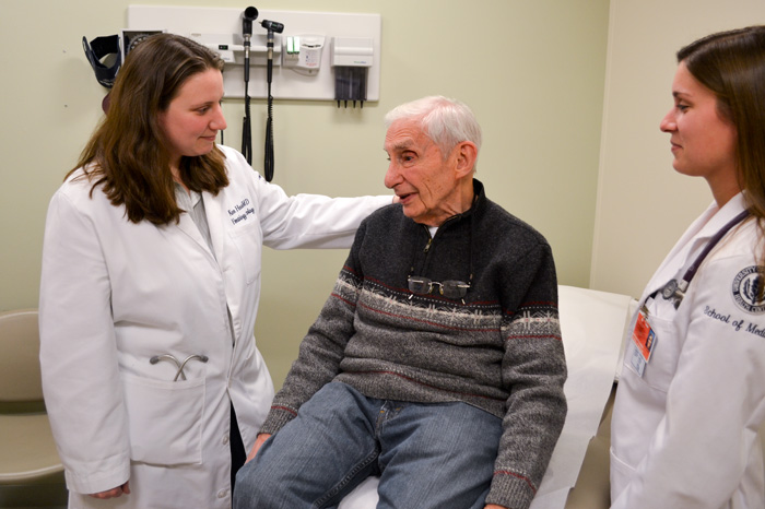 Dr. Karen Hook (left) with a patient, observed by medical student Nicole Albino. (Chris DeFrancesco/UConn Health Center Photo)