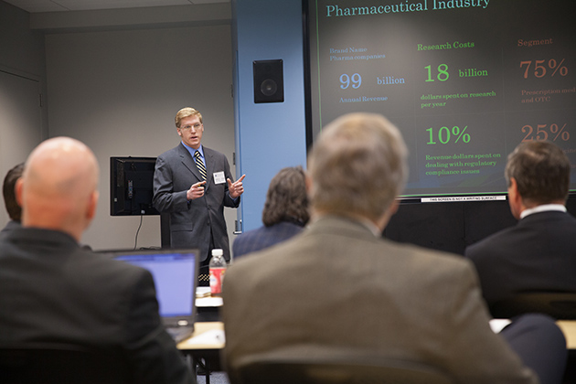 Robert Johnson '13 (BUS) explains a proposal to IBM executives on how its Watson supercomputer could be used in the pharmaceutical industry. Johnson and six other students in the School of Business developed their proposals in a collaboration with IBM Watson through a class at UConn's Stamford Learning Accelerator. (Zach Wussow for UConn)