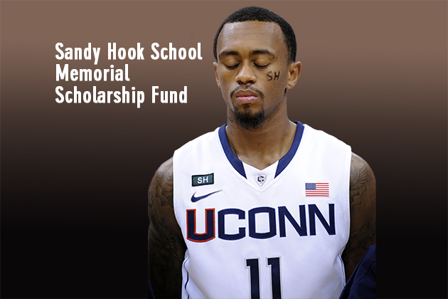 Connecticut's Ryan Boatright participates in a moment of silence honoring those killed in a school shooting in Newtown, Conn., last Friday. The service was held before an NCAA college basketball game between Connecticut and Maryland Eastern Shore in Hartford, Conn., Monday, Dec. 17, 2012. (AP Photo/Fred Beckham)