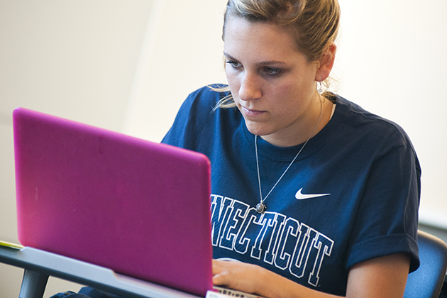 A student works on her computer in the new classroom building. (Al Ferreira for UConn)