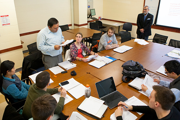 (standing) Vishal Dhagat, Ph.D. student in engineering, talks during a course designed to support graduate students with potential entrepreneurial ideas on Feb. 12, 2013. (Sean Flynn/UConn Photo)