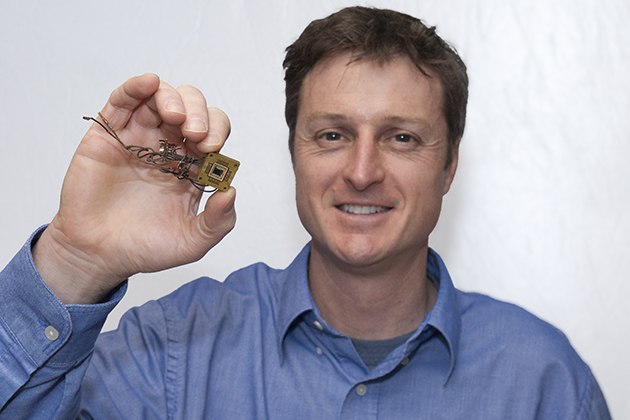 Brian Willis in bimolecular and chemical engineering holds a rectenna device on Jan. 29, 2013. (Sean Flynn/UConn Photo)