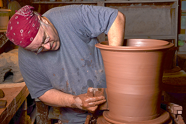 A photo of Guy Wolff at work in his studio from the book Guy Wolff: Master Potter in the Garden, by Suzy Staubach. Wolff's horticultural wares grace gardens and homes throughout the U.S. (Photo by Joseph Szalay)