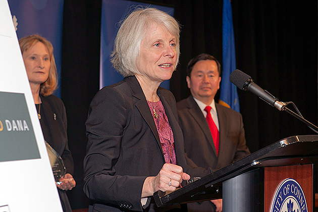 DECD Commissioner Catherine Smith accepts her Innovations Champion award as UConn's Vice President of Economic Development Mary Holz-Clause and Provost and Executive Vice President Mun Choi look on. (Tom Hurlbut for UConn)