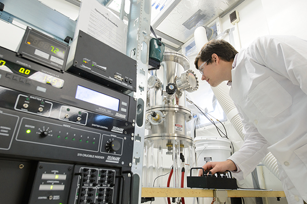 Stephen Stagon a doctoral student of mechanical engineering, with nanorod growing apparatus at the Longley Building on April 23, 2013. (Peter Morenus/UConn Photo)