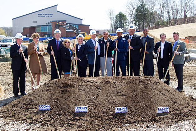 UConn officials and friends celebrate groundbreaking for the University’s new basketball practice facility on April 16. From left, UConn supporter Sonny Whelen; President Susan Herbst; Board of Trustees Chairman Larry McHugh; Rosalind Shenkman; UConn Foundation Board of Directors Chairman Mark Shenkman; UConn supporter Peter Werth; women's basketball player Kaleena Mosqueda-Lewis; men's basketball player Ryan Boatright; Athletics Director Warde Manuel; men's basketball head coach Kevin Ollie; women's basketball head coach Geno Auriemma; and UConn Foundation Board of Directors Member Robert Skinner. (Steve Slade '89 (SFA) for UConn)