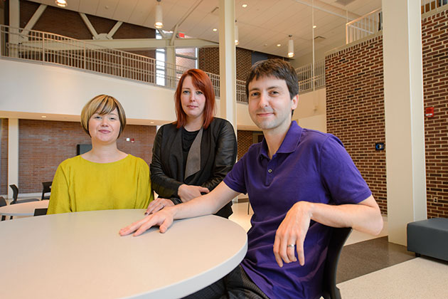 Erika Skoe, assistant professor of speech, language & hearing, left, Nicole Landi, assistant professor of psychology, and Jon Sprouse, associate professor of linguistics, at the Charles "Skip" Lowe Atrium on Sept. 20, 2013. (Peter Morenus/UConn Photo)