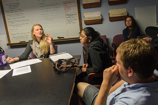 Jackie Wattles '14 (CLAS) talks to other student writers during a weekly meeting at the Daily Campus on Oct. 7, 2013. (Ariel Dowski/UConn Photo)