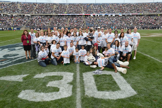 Members of the Stamos/Heerdt/Vartelas/Vlandis family pose for UConn's "Biggest UConn Family" portrait at Rentschler Field on Saturday, Oct. 12, 2013. Almost 60 family members received an exclusive Homecoming package, including tickets to the game, admission to the Alumni Association BBQ, T-shirts, and on-field recognition. (Peter Morenus/UConn Photo)