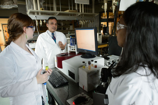 Challa Kumar, professor of chemistry, center, with graduate students Caterina Riccardi, left, and Inoka Deshapriya on Oct. 28, 2013. (Peter Morenus/UConn Photo)