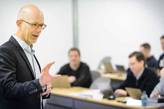 Timothy Folta, professor of management, leads a class at the Graduate Business Learning Center in Hartford on Dec. 6, 2013. (Peter Morenus/UConn Photo)