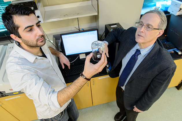 Altug Poyraz, left, a graduate student, with Steven Suib, Board of Trustees Distinguished Professor of Chemistry. According to Suib, some of the greatest benefits of being an academic inventor are the opportunities it allows him to provide to his students, many of whom will work in industry after graduating from UConn. (Peter Morenus/UConn File Photo)