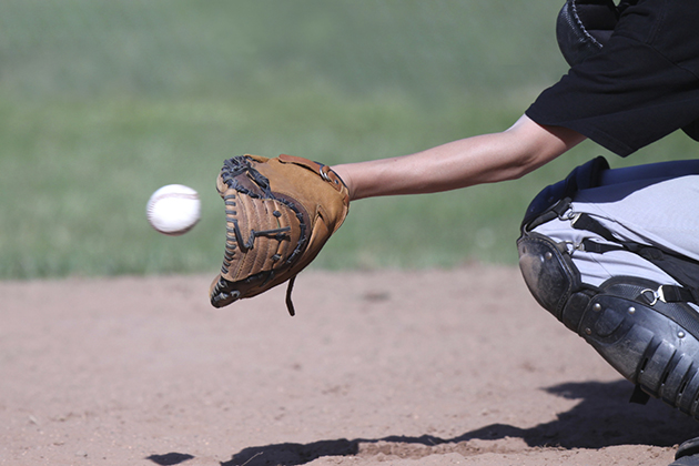 Baseball flying into a waiting catcher's mitt. Focus on mitt; ball slightly blurred to show speed and motion.(istock photo)