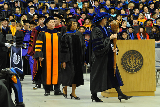 Sally Reis, Board of Trustees Distinguished Professor of Educational Psychology, bears the mace at the head of the Academic Procession, at the start of a UConn commencement ceremony. (UConn File Photo)