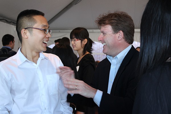 Justin Xu, a Ph.D. student in actuarial science, talks to Matt Phelan, a Wall Street stockbroker, about the National Retirement Sustainability Index project Xu has developed. Phelan is working with the Goldenson Center to help design, price, and market a patented insurance product. (Christine Buckley/UConn Photo)