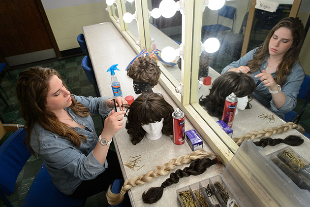 Bailey Rosenberg '14 (SFA) styles a wig backstage at the Harriet S. Jorgensen Theatre on May 22, 2014. (Peter Morenus/UConn Photo)