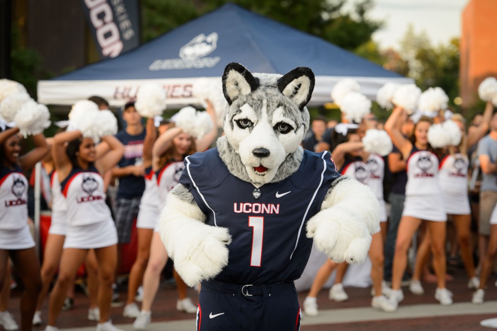 Jonathan the Husky dances with cheerleaders during the UConn Football pep rally held on Fairfield Way on Aug. 28. (Peter Morenus/UConn Photo)