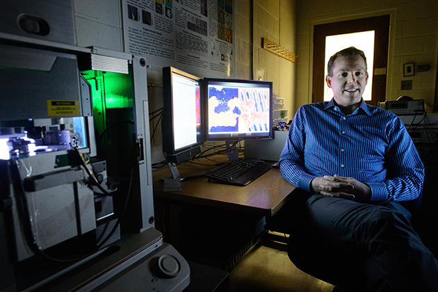 Brian Huey reviews microscope data at IMS on Jan. 16, 2015. (Peter Morenus/UConn Photo)